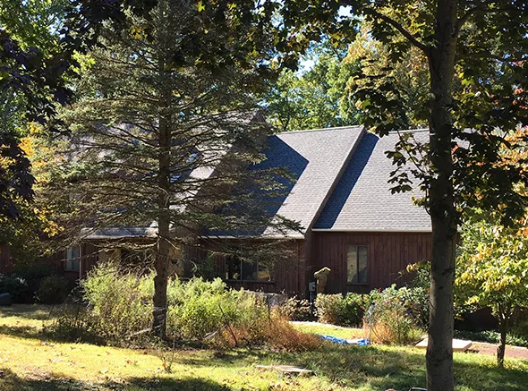 Completed asphalt shingle roof replacement showcasing durable and stylish materials.