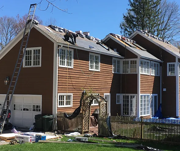 Fast local roof damage repair services team working efficiently to replace damaged shingles.