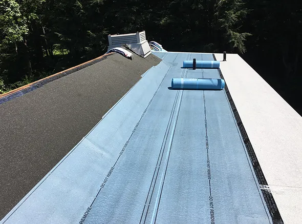 Modern roofing system installation showcasing a high-end design on a luxury residence.