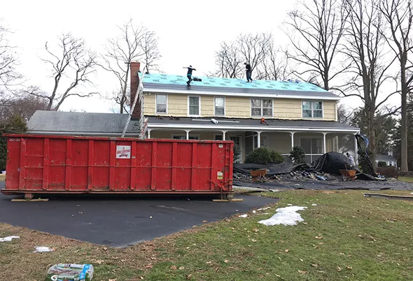 Residential roof restoration services replace worn-out shingles on a family home.