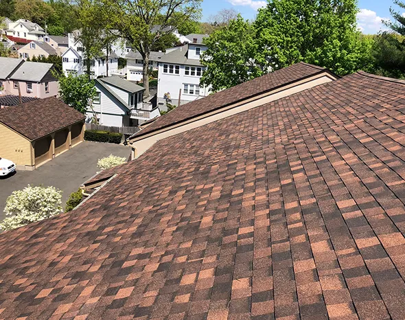 Roofing experts perform a roof shingle replacement using high-quality shingles.